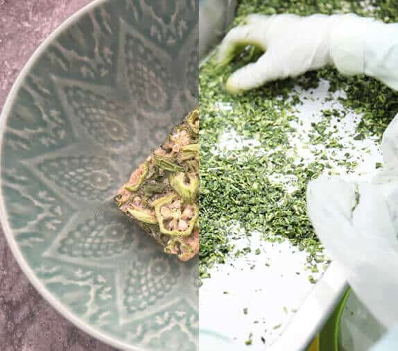 A decorative bowl with a pattern, beside a hand in a glove chopping herbs on a cutting board.